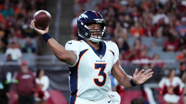Denver Broncos quarterback Russell Wilson (3) throws a pass against the Arizona Cardinals during the first half at State Farm Stadium.